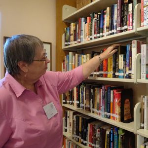 Woman in front of library shelves