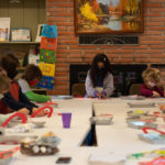 Darlene and a group of children working on a Valentine's project