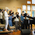 The choir with Julie at the piano