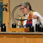 Rev. Heather extinguishing the chalice