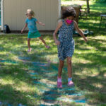 wo girls on the hopping and hopscotch parts of the obstacle course
