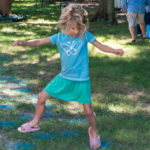 A girl on the hopscotch part of the obstacle course