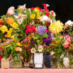 Flowers on the Altar with the words Flower Communion June 5, 2022