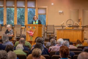 Rev. Heather at the podium speaking to the congregation.