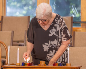 Deanna Duby lights the candles for joys and sorrows.