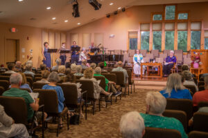 The congregation and vocal team sings "There is More Love Somewhere."