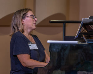 Prof. Heather A. Hamilton, CFE Director, plays the piano for the service.