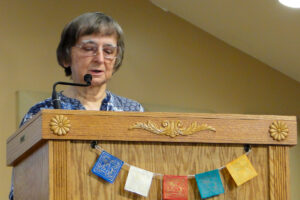 Susan Geokler, Worship Associate, gives the Reading at the pulpit..