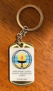 The UUSD keychains say Open minds, loving hearts, and helping hands and our website. One side is our logo.